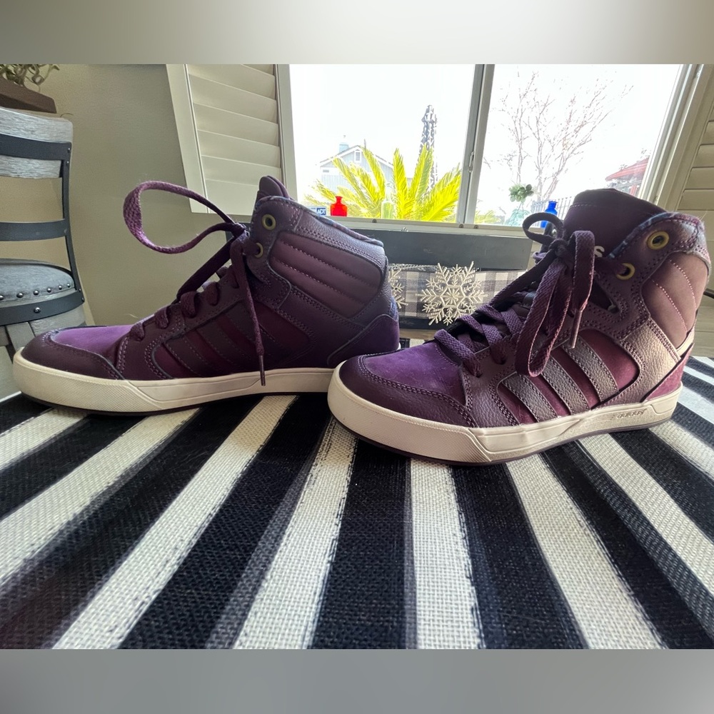 Burgundy Adidas high tops.
